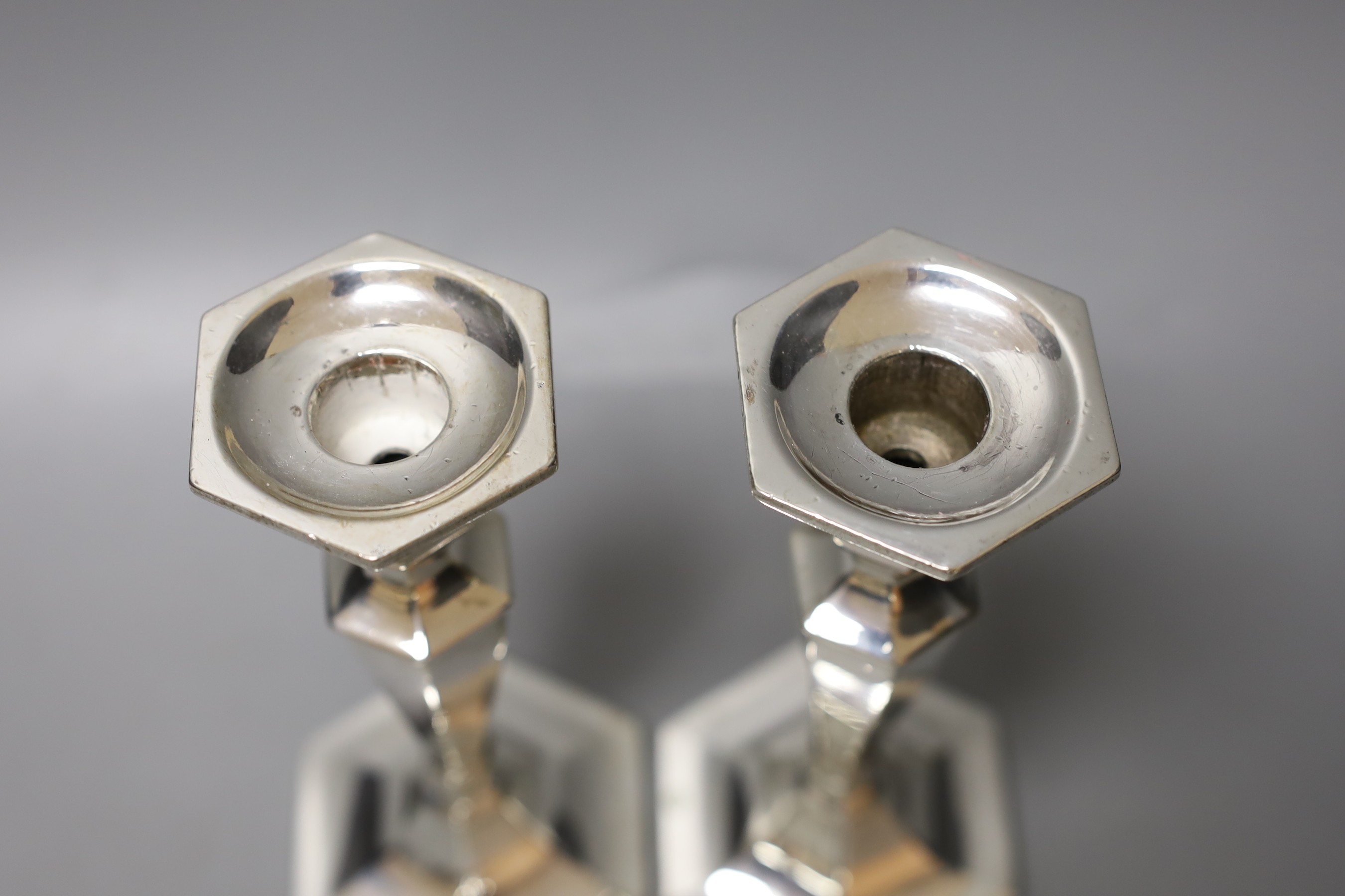 A pair of sterling hexagonal candlesticks, maker L.H?, 17.5cm, gross 561 grams.